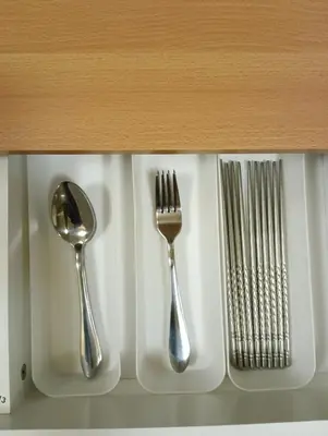 two utensils are sitting on a shelf at Lovers' Cozy 1BR Condo Near Mall and Airport with Free Netflix Premium and 100 MBPS WiFi in Manila