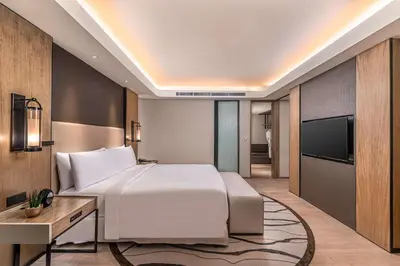 a hotel room with a bed and a television at Conrad Manila in Manila