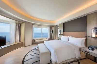 a hotel room with a large bed and a television at Conrad Manila in Manila