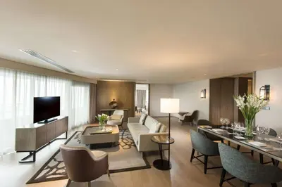 a living room with a couch and a table at Conrad Manila in Manila