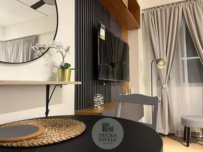 a dining room with a table and a mirror at Deck&Dwell in Trece Martires