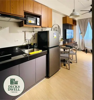 a kitchen with a refrigerator and a dining room at Deck&Dwell in Trece Martires