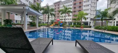 a swimming pool with a playground in a building at Deck&Dwell in Trece Martires
