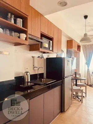 a kitchen with a stainless steel refrigerator and a table at Deck&Dwell in Trece Martires