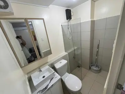 a bathroom with a toilet and a sink and a shower at Enzo vibes in Manila