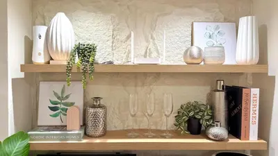 a shelf with vases and other items on it at 1-Bedroom Cozy Haven Sorrento Oasis in Manila