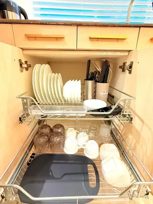 a kitchen drawer with plates and dishes in it at 1-Bedroom Cozy Haven Sorrento Oasis in Manila