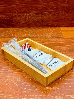 a wooden box with toothbrushes in it on a table at 1-Bedroom Cozy Haven Sorrento Oasis in Manila