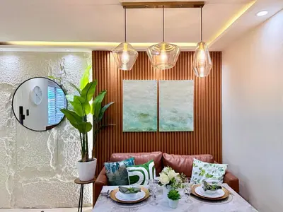 a dining room with a table and some lights at 2-Bedroom Cozy Haven Sorrento Oasis in Manila