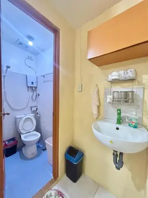 a bathroom with a sink and a toilet at Solano Transient House in Manila