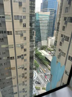 a view from a window of a city with buildings at Spacious 1BR Loft with Flex Room in BGC in Manila