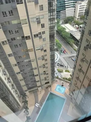an overhead view of a building with a swimming pool at Spacious 1BR Loft with Flex Room in BGC in Manila