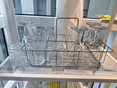 a rack of glasses sitting on a shelf at Spacious 1BR Loft with Flex Room in BGC in Manila