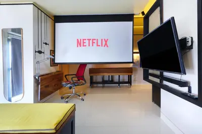 a screen in a room with a tv and a chair at Starwars Retreat Gaming & 84 inch Movie & Near Mall in Manila