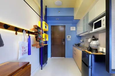 a kitchen with blue and white walls and a door at Starwars Retreat Gaming & 84 inch Movie & Near Mall in Manila