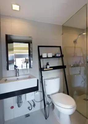 a bathroom with a toilet and a sink and a mirror at Starwars Retreat Gaming & 84 inch Movie & Near Mall in Manila