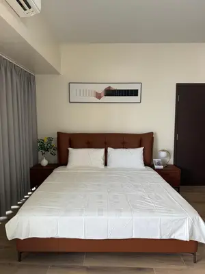 a bedroom with a large bed with white sheets at HomeMadeLuxury 3 Bedrooms Seaview Sunset View Near Manila Airports Okada MOA in Manila