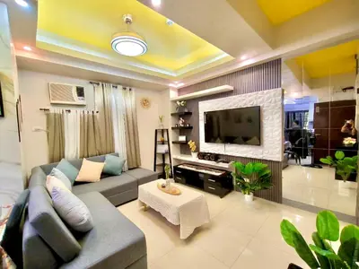a living room with a couch and a tv at NAIA 101 Condotel Newport Luxe Stay Pasay in Manila