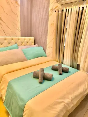 two beds with towels on top of them at NAIA 101 Condotel Newport Luxe Stay Pasay in Manila