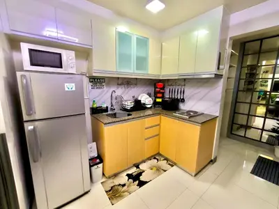 a kitchen with a refrigerator and a floor in the floor at NAIA 101 Condotel Newport Luxe Stay Pasay in Manila