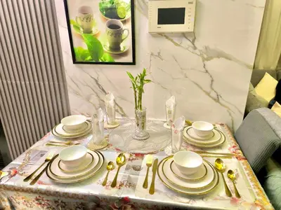 a table with plates and silverware on it at NAIA 101 Condotel Newport Luxe Stay Pasay in Manila