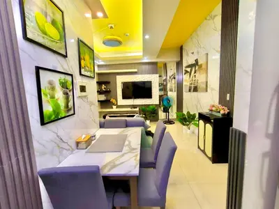 a dining room with a table and purple chairs at NAIA 101 Condotel Newport Luxe Stay Pasay in Manila