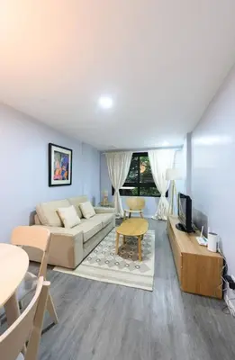 a living room with a couch and a table at House in Makati, Poblacion in Manila