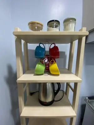 a shelf with a tea kettle and bowls on it at House in Makati, Poblacion in Manila