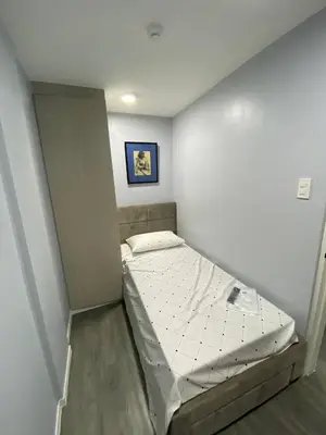 a small bedroom with a bed in a room at House in Makati, Poblacion in Manila