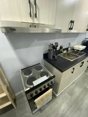 a kitchen with a stove and a sink at House in Makati, Poblacion in Manila