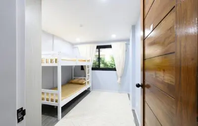 a small room with bunk beds and a door at House in Makati, Poblacion in Manila