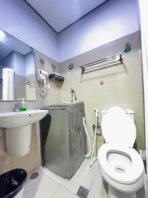a bathroom with a toilet and a sink at MOA GRAND STAY Suite #05 Spacious Unit & Sun Rise View in Manila