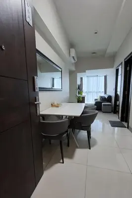 a living room with a white table and chairs at 1BR at the FORT BGC near Malls, Restaurants & Shops in Manila