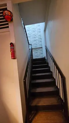 a staircase in a building with a stair case at Nemar Ladies Dormitel in Manila
