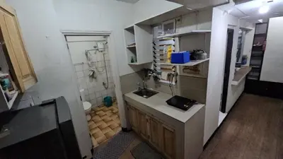 a small bathroom with a sink and a toilet at Nemar Ladies Dormitel in Manila