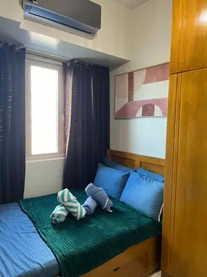 a bedroom with a bed with a stuffed animal on it at Smdc Coast Resideces in Manila