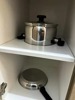 a slow cooker sitting on a shelf in a kitchen at Cozy MOA Condo Perfect for 2 in Manila