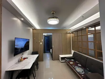 a living room with a couch and a table at Cozy MOA Condo Perfect for 2 in Manila