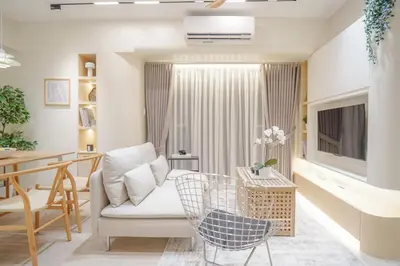 a living room with a chair and a television at Aston Residences 2BR in Pasay-up to 6pax in Manila