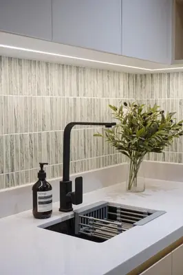 a kitchen sink with a bottle of soap and a plant at Aston Residences 2BR in Pasay-up to 6pax in Manila