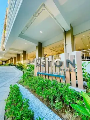 a building with a sign that reads next to aania at Aston Residences 2BR in Pasay-up to 6pax in Manila