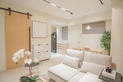 a living room with a white couch and a table at Aston Residences 2BR in Pasay-up to 6pax in Manila