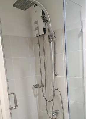 a shower with a shower head in a bathroom at Basic one-bedroom condo at Sea Residences in Manila