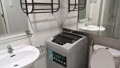 a small bathroom with a toilet and a sink at Basic one-bedroom condo at Sea Residences in Manila