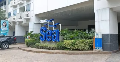 a sign for a sa store in front of a building at Basic one-bedroom condo at Sea Residences in Manila