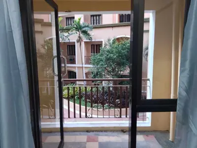 a view from a window of a balcony with a building at 1 bedroom condo unit for 4 with balcony, pool, WIFI at Newport across NAIA T3 in Manila