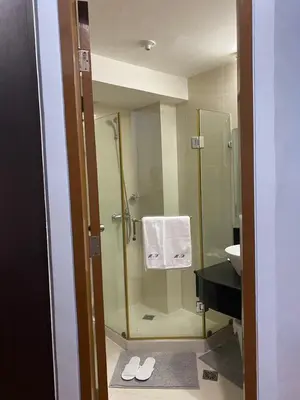 a bathroom with a shower and a sink at 1 bedroom condo unit for 4 with balcony, pool, WIFI at Newport across NAIA T3 in Manila