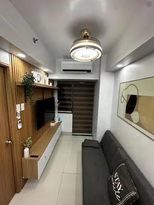a living room with a couch and a ceiling at Shore 3 Residences with WiFi, Balcony, Pool in Manila
