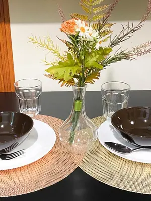 a vase with flowers in it sitting on a table at 1BR- Axinite walking distance to MOA, PICC, SMX, Worldtrade near NAIA and Star City in Manila