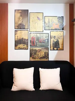 a room with a black couch with pictures on the wall at 1BR- Axinite walking distance to MOA, PICC, SMX, Worldtrade near NAIA and Star City in Manila